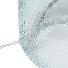 a close up of a glass vase on a white background with water swirling around it