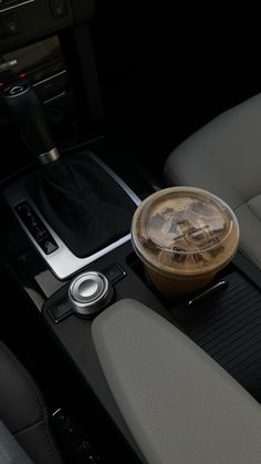 a drink sitting on the center console of a car