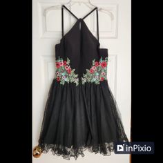 Blondie Nites Black Tulle Homecoming Dress, Size 13 Juniors, Brand New With Tags, Features: -Halter Style Neckline -Mesh Beaded Floral Side Inserts -Tulle Skirt Floral Embroidered Dresses For Homecoming And Prom, Elegant Floral Embroidery Dresses For Homecoming, Elegant Floral Embroidery Homecoming Dresses, Black Homecoming Dress For Holiday, Summer Embellished Evening Dress For Homecoming, Summer Homecoming Embellished Evening Dress, Black Embellished Dress For Prom Season, Black Embellished Dress For Prom, Embellished Dresses For Homecoming And Holidays