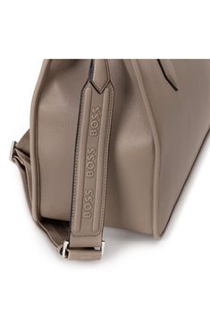 Gleaming logo hardware lends signature appeal to a structured tote fitted with a spacious interior and multiple straps perfect for on-the-go wear. Open top   Shoulder straps; removable, adjustable crossbody strap   Structured silhouette with flat base for stability   Lined   Synthetic/textile   Imported   Hugo Boss/BOSS/HUGO has received the Fair Labor Association accreditation, which signifies that the company has effective systems and procedures in place to successfully uphold fair labor stand Modern Leather Bags With Adjustable Straps, Modern Leather Bag With Adjustable Straps, Travel Shoulder Satchel With Logo Hardware, Modern Workwear Bag With Logo Hardware, Modern Satchel With Logo Hardware And Double Handle, Travel Satchel With Logo Hardware And Double Handle, Travel Satchel With Shoulder Strap And Logo Hardware, Travel Satchel With Logo Hardware, Travel Satchel With Double Handle And Logo Hardware