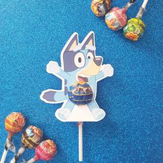 an assortment of lollipops and marshmallows on a blue carpet