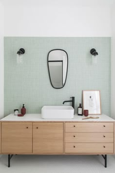 a bathroom with two sinks and a mirror on the wall