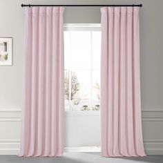 a pink curtain hanging in front of a window