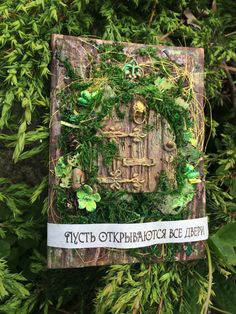 a piece of wood with plants growing out of it and an inscription on the side