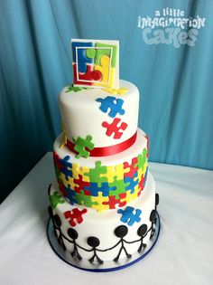 a multi layer cake decorated with puzzle pieces