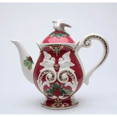 a red and white tea pot with birds on it