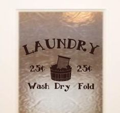 a sign that says laundry wash dry fold on the side of a door with an image of a bucket