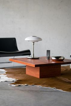 a modern living room with two chairs and a coffee table