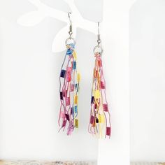 Handmade Pastel Rainbow tassel dangle earrings.  These earrings are eye-catching for a unique look. They have a beautiful flowy, boho feel and are very light-weight - it doesn't even feel like you are wearing them!  They are fishhook style dangle earrings with a clear back to keep them in place. They are made with silver metal and pastel rainbow ladder yarn. Refer to Earrings Lengths photo for length descriptions. Perfect accessory for Easter, Spring, Pride Celebration or simply any day! Earrings can easily be trimmed shorter, if desired, with a sharp pair of scissors. Earrings are one-of-a-kind. Due to different computer monitor and phone displays, colors may vary slightly in person. Note: Earrings pictured in 2nd photo are only to show how this style of earrings appear as worn. They are Rainbow Fringe Earrings As Gift, Rainbow Tassel Earrings For Gifts, Rainbow Dangle Tassel Earrings Gift, Colorful Dangle Tassel Earrings Gift, Rainbow Tassel Dangle Earrings, Rainbow Dangle Tassel Earrings, Rainbow Fringe Dangle Earrings, Rainbow Dangle Earrings With Fringe, Multicolor Fringe Dangle Earrings