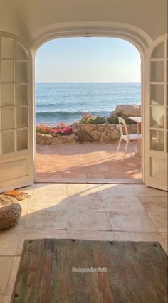 an open door leading to the ocean