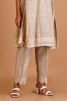 Ivory jute silk angrakha tunic with polka dots and lace embroidery. Comes with pant and an inner. - Aza Fashions Fitted Beige Lace Work Sets, Festive Beige Lace Work Sets, Fitted Beige Sets With Lace Work, Fitted Beige Lace Sets, Fitted Beige Sets With Cutdana Detail, Beige Cutdana Long Sleeve Sets, Beige Long Sleeve Sets With Cutdana, Traditional Sets With Yoke For Spring, Fitted Cream Self Design Sets