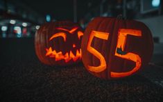 two carved pumpkins with the number 55 carved into them