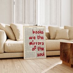 a book is sitting on the floor in front of a couch with pillows and pillow cases