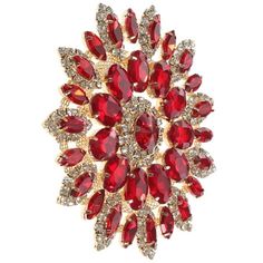 a red brooch with lots of diamonds on it