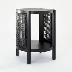 the side table is made from black wood and has an open mesh design on it