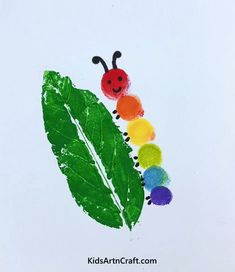 a child's drawing of a caterpillar on a leaf