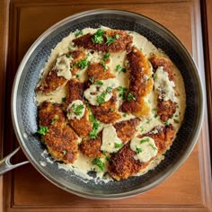 a metal pan filled with food on top of a wooden table