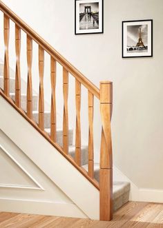 the stairs are made of wood and have handrails that match with the wall