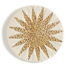 a white plate with an intricate design on the top and bottom, made out of woven material