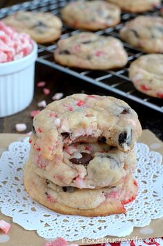 two chocolate chip cookies with pink and white sprinkles are stacked on top of each other