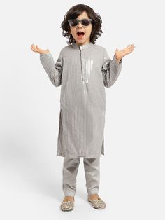 Grey Sequence Kurta with Pyjama (Set of 2) Now is the perfect moment to stand out in elegant kurtas! Select a fashionable kurta made from luxurious material cotton, adorned with classic patterns and designs. Match it with cozy pajamas. Your flawless style will surely capture everyone's attention! Age group: 9-10 years                      10-11 years Additional Details: Material- Cotton Pattern- Embellished/ Sequined Type of work- Embellished/ Sequined Care Instructions- Dry Clean Pack contains- 1 Kurta, 1 Pyjama Apparel Photoshoot, Cozy Pajamas, Kurta Pajama, Photoshoot Concept, Collar Neck, Clothing Sets, Kids Pajamas, Full Sleeves, Classic Pattern