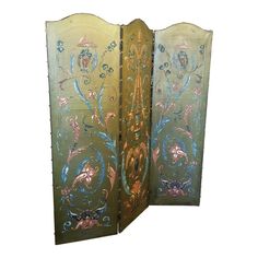 an ornately decorated room divider with flowers and leaves painted on the glass doors