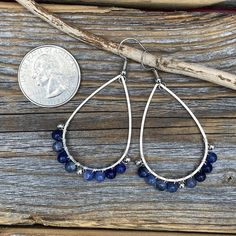 Silver Teardrop Earrings wire-wrapped with Sodalite Semi-Precious Beads and Silver Spacer Beads: These earrings are light weight, comfortable, simple and fun. Throw them on with any outfit and they will definitely add some pop They are approximately 2.25 inches in length and 1.15 inches at the widest portion. Included are nickel free ear wires and silicone earring backs. If you would like these in a different color or size, please let me know as I also do customized orders. To view more of my or Silver Wire-wrapped Teardrop Earrings, Adjustable Teardrop Linear Earrings With Ear Wire, Silver Teardrop Wrap Earrings, Wire Wrapped Teardrop Hoop Earrings, Hypoallergenic Silver Teardrop Beaded Earrings, Teardrop Chandelier Earrings For Jewelry Making, Teardrop Metal Wrap Earrings As Gift, Wire Wrapped Metal Chandelier Earrings, Teardrop Wrap Earrings As Gift