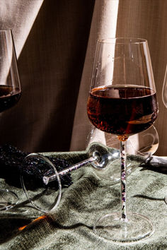 three glasses of wine sitting on top of a table