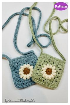 two crocheted purses sitting on top of a white table next to each other