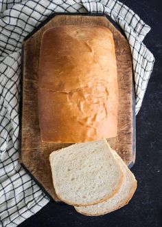 a loaf of bread sitting on top of a wooden cutting board