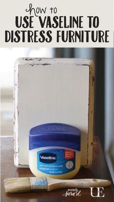 an old wooden box sitting on top of a table next to a paintbrush