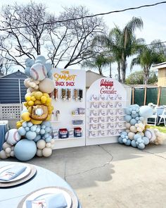 a table with balloons and baseballs on it