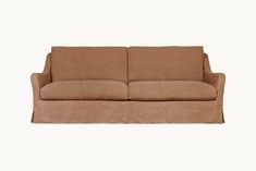 a brown couch sitting on top of a white wall