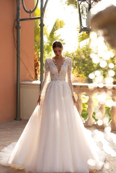 a woman in a wedding dress standing outside