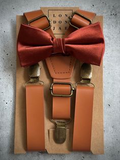 You can choose either the Bronze orange pre-tied bow tie OR the Bronze orange long neck tie to create your own set, designed for your groom, groomsmen and ring bearers in your wedding. Adult sizes fit Big & Tall 6'8+. Please add individual items to your cart, using the discount code THESETUP to receive our 10% 0ff discount for sets. Shopper must order more than 1 item from this listing. Small, Large, Teen and Adult "Bow Tie Sets" include 1 pair of 1" caramel brown suspenders w/ 1 bronze satin pre tied bow. All other bronze silk items can be purchased individually in drop down menu. Suspenders can be purchased individually though the links below.  Adult "Neck Tie Sets" include 1 pair of skinny 1" caramel brown suspenders and 1 bronze satin long neck tie only. All other bronze silk items can Brown Bow Tie For Wedding, Brown Bow Tie For Wedding And Father's Day, Dapper Brown Bow Tie For Wedding, Dapper Brown Bow Tie For Party, Brown Bow Suit And Tie Accessories For Party, Brown Dapper Bow Tie For Party, Brown Satin Bow Tie For Party, Adjustable Brown Bow Tie For Party, Classic Brown Bow Tie For Wedding