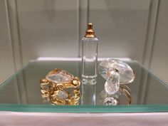 an assortment of rings and perfume bottles on display