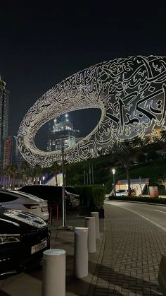 a car parked in front of a building with an intricate design on it's side