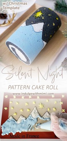 a cake roll is decorated with blue and white icing, stars and the words silent night on it