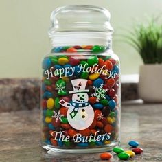 a glass jar filled with candy sitting on top of a counter