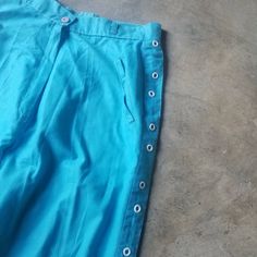 "Adorable vintage 70s 80s Pants - unique high waisted pant in bold turquoise with white metal open donut details going up both sides of the legs zip and button closure at waist label Reggata Paris tag size 11/12 no fabric tags - feels like cotton/poly blend to me but if you have any fiber allergies or strong preferences, best to avoid as there aren't tags to confirm fabric content size/fit estimated fit xs/s approximate measurements waist approx 12.5-13.25\" stretched taut hip 20.5\" taut rise 1 80s Pants, Pants Unique, Pants Blue, Fabric Tags, High Waisted Trousers, White Metal, Button Detail, High Waisted Pants, Vintage 70s