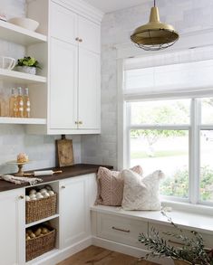 a kitchen with white cabinets and wooden flooring is featured in the instagramt