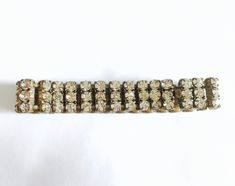 "Beautiful 1950's bracelet - signed made in Czechoslovakia. This piece has all its original stones and the box clasp works properly and holds the bracelet securely. It measures 7 inches long by 1/2\" wide. The prongs and underside of the bracelet are antiqued gold. Gorgeous vintage bracelet with free First Class domestic shipping. US sellers are not authorized to collect VAT/customs fees for other countries. Attention International Buyers! Please be aware that there may be VAT, import or customs Vintage Adjustable Bracelets With Stones, Crystal Bracelet With 17 Jewels, Metal Rhinestone Costume Jewelry Bracelets, Adjustable Costume Jewelry Bracelets With Stones, Vintage Formal Bracelets With Stones, Adjustable Jeweled Costume Jewelry Bracelets, Adjustable Jeweled Costume Bracelets, Vintage Crystal Bracelets For Formal Occasions, Sparkling Crystal Bracelet In Costume Jewelry Style