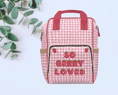 a pink and white checkered lunch bag with the words so berry loved printed on it