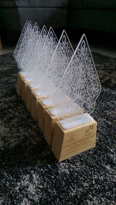 six wooden candles are lined up in a row on top of a carpeted floor