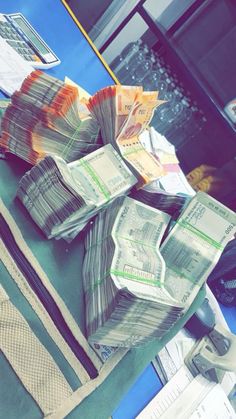 stacks of money sitting on top of a table