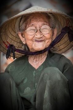 an old woman wearing a hat and glasses