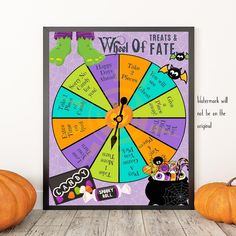 a wheel of fate poster on a table next to pumpkins