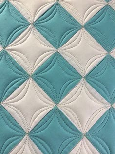 a close up view of a blue and white quilt