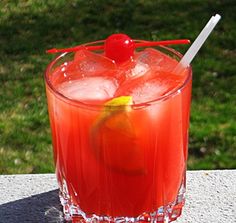 a red drink sitting on top of a table