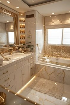 a bathroom with marble counter tops and gold accents